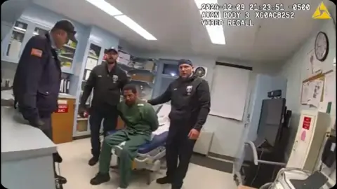 New York State Attorney General's Office Screenshot of bodycam footage showing officers holding down Robert Brooks in a prison infirmary.