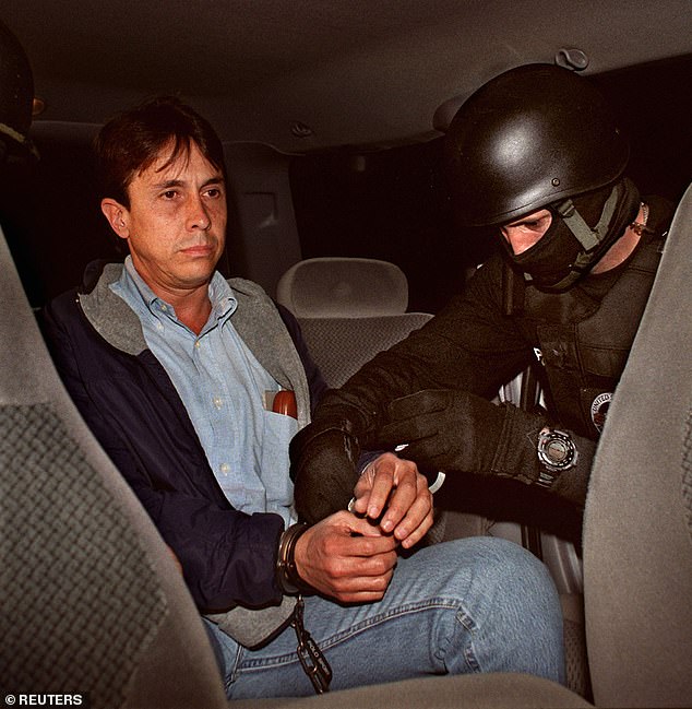 Fabio Ochoa, reputed Colombian drug kingpin, sits in a vehicle following his extradition from Bogota to Miami in 2001