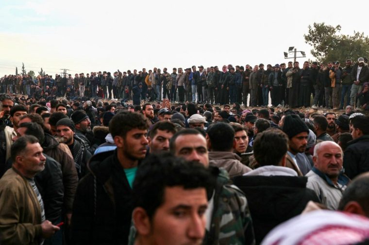 TOPSHOT - People gather at the Sednaya prison in Damascus looking for loved ones on December 9, 2024. Syrian rescuers searched the Sednaya jail, synonymous with the worst atrocities of ousted president Bashar al-Assad's rule, as people in the capital on December 9 gathered to celebrate a day after Assad fled while Islamist-led rebels swept into the capital, ending five decades of brutal rule over a country ravaged by one of the deadliest wars of the century. (Photo by OMAR HAJ KADOUR / AFP) (Photo by OMAR HAJ KADOUR/AFP via Getty Images)