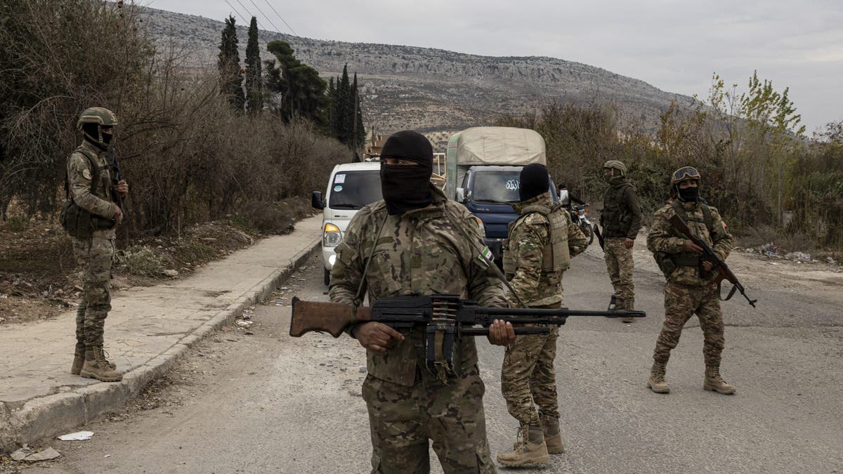 People holding guns in military uniforms