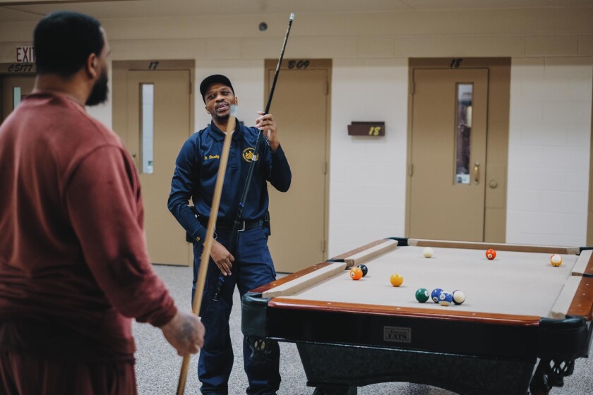 A correctional officer plays a game of pool with an incarcerated resident in the Little Scandinavia unit at SCI Chester.