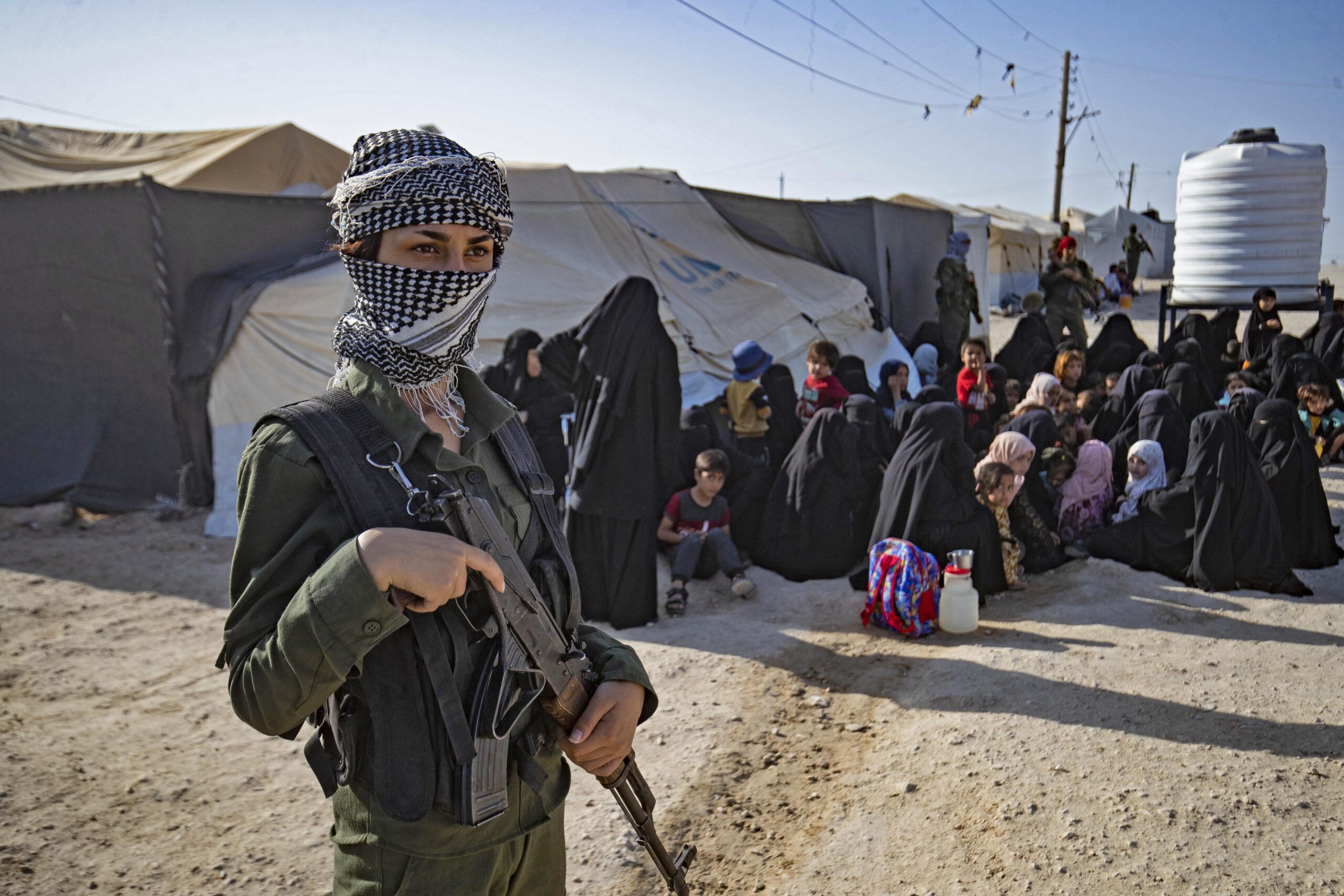 A Kurdish female soldier stands guard at the al-Hol camp in Syria.