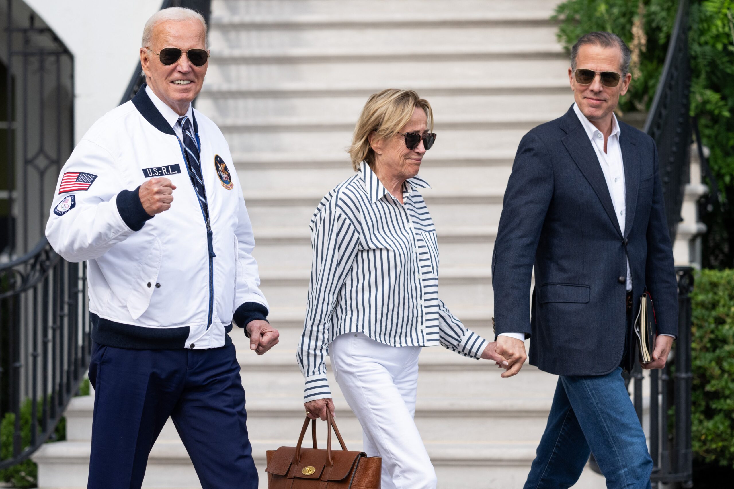 President Biden, his sister, and son walking together.