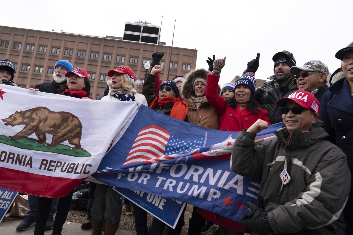 Supporters of President Trump's Jan. 6 pardons gather Tuesday at the D.C. Central Detention Facility in Washington.