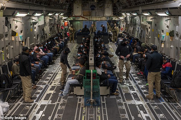 In this handout provided by the U.S. Department of Defense, illegal immigrants await takeoff for a removal flight at the Tucson International Airport, Ariz., Jan. 23, 2025. Under the direction of U.S. Northern Command, U.S. Transportation Command is supporting Immigration and Customs Enforcement removal flights by providing military airlift