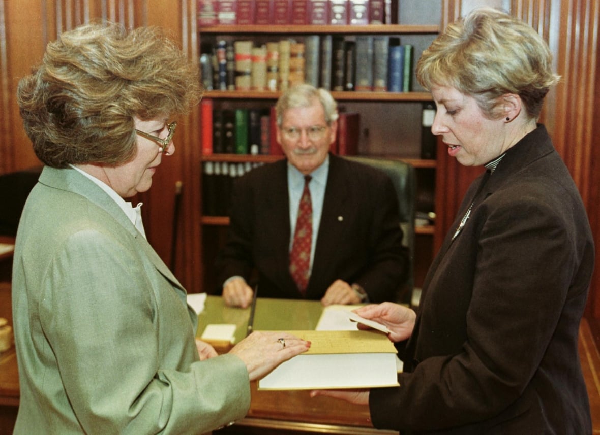 Louise Arbour (L) takes an oath from Louise Meagher, Deputy Registrar (R), to become a Supreme Court of Canada judge