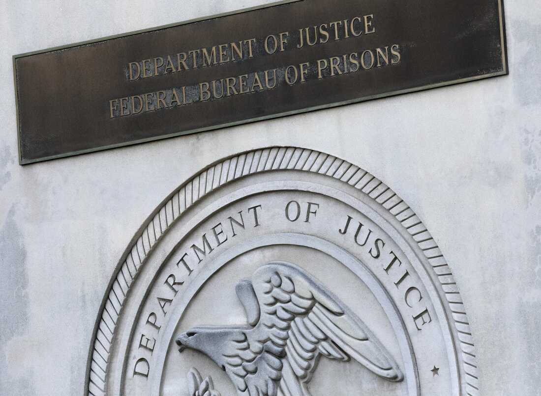 A sign for the Department of Justice Federal Bureau of Prisons is displayed in the Brooklyn borough of New York on July 6, 2020.