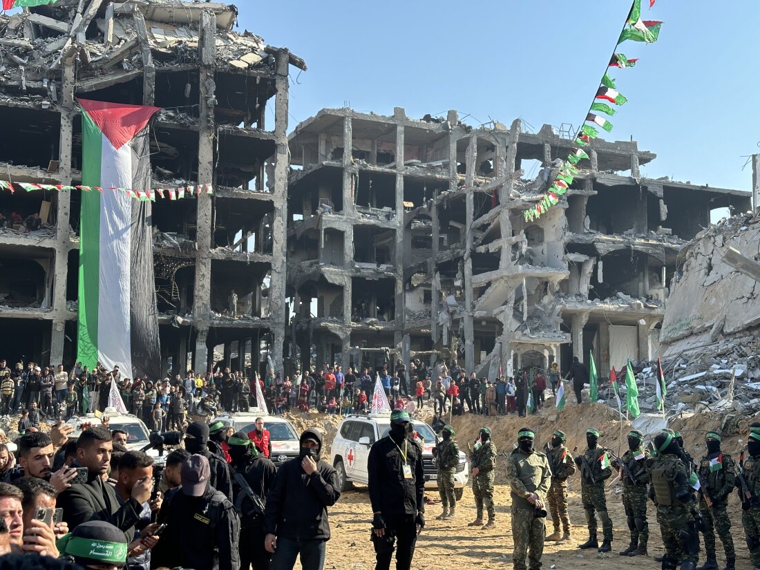 Vehicles with the International Committee of the Red Cross arrive, while Palestinian militants and civilians stand by, for the release of Israeli hostage Agam Berger in Jabalia, Gaza Strip, Thursday.