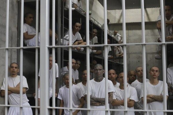 Inmates attend a class on social behavior from inside their shared cell during a press tour of the Terrorism Confinement Center, or CECOT, in Tecololuca, El Salvador, Oct. 12, 2023. (AP Photo/Salvador Melendez, File)