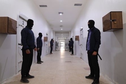 Security guards standing outside prison doors