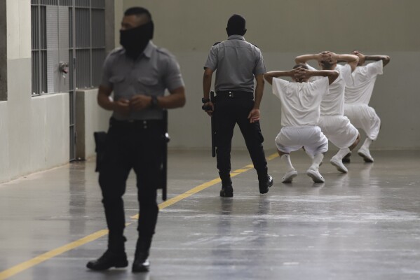 Inmates exercise under the watch of prison guards during a press tour of the Terrorism Confinement Center, or CECOT, in Tecololuca, El Salvador, Oct. 12, 2023. (AP Photo/Salvador Melendez, File)