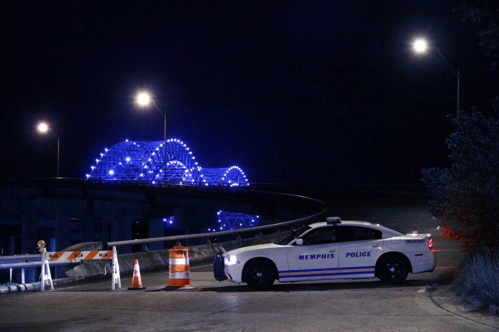 A police car blocks entry onto the Hernando DeSoto Bridge in Memphis, Tennessee Tuesday night, May 11, 2021. A crack was discovered on the Hernando DeSoto bridge Tuesday. Traffic has been shut down on Interstate 40 crossing over the Mississippi River from Memphis into Arkansas. Department of Transportation says that it could be months before the bridge can be reopen.