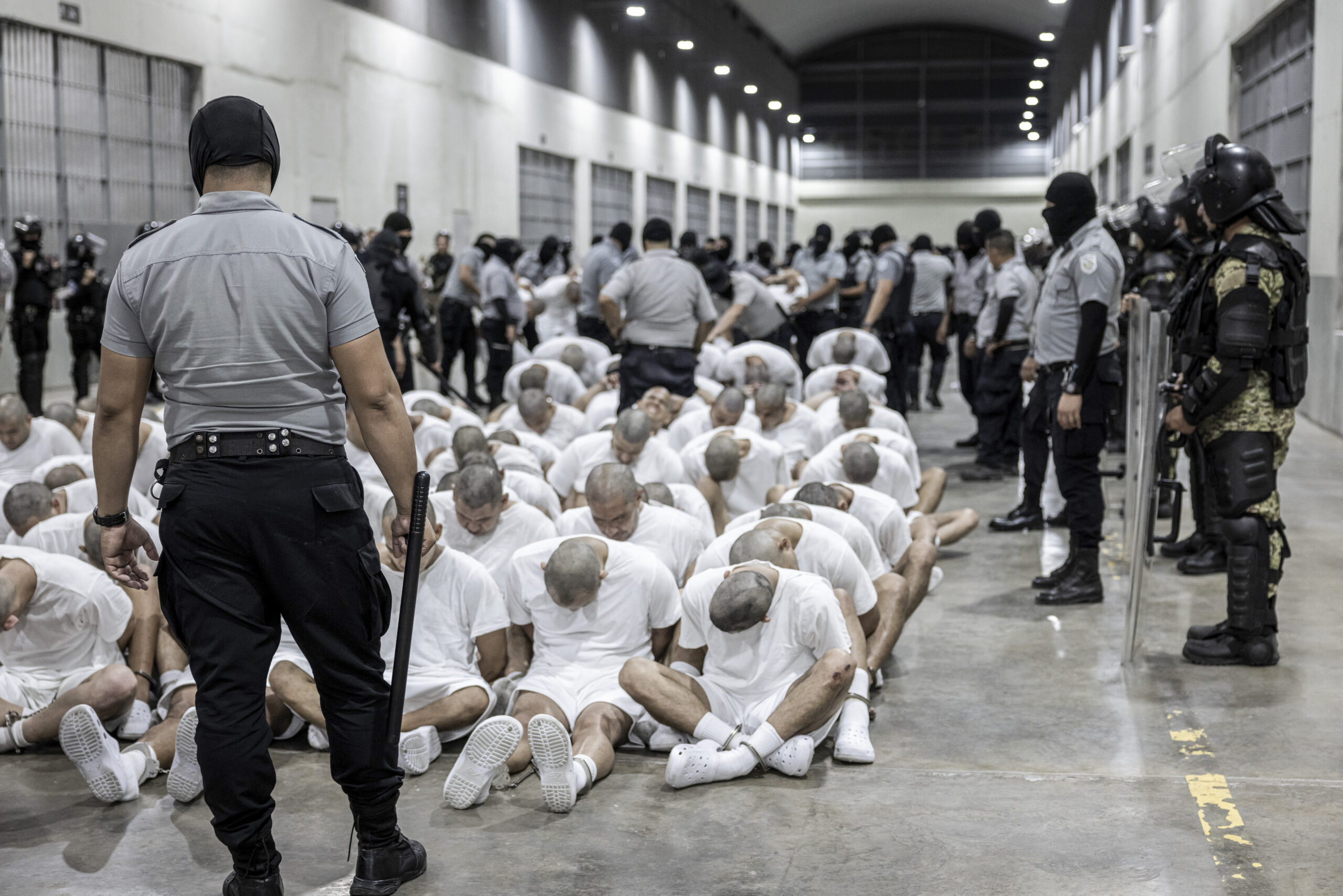 Prison guard transferring deportees in El Salvador.