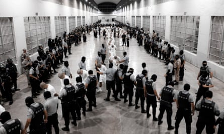 Salvadoran police officers escort alleged members of the Venezuelan gang Tren de Aragua recently deported by the US government to be imprisoned in Cecot prison, as part of an agreement with the Salvadoran government, in Tecoluca, El Salvador, in this handout image obtained 16 March 2025.