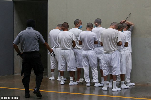 Inmates wait to be attended by health personnel, during a tour in the 