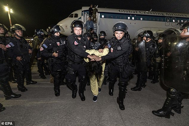 Guards at the Terrorism Confinement Center (CECOT) transferring alleged members of the criminal gang known as Tren de Aragua, in San Luis Talpa, El Salvador, 16 March 2025.