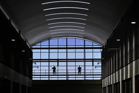 Prison officials stand guard on a pavilion
