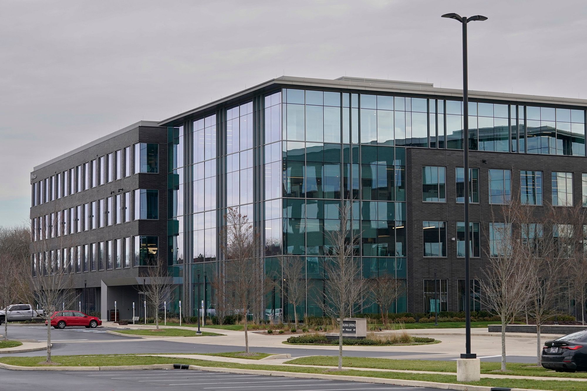 A photo shows a gray and blue building in the center. 