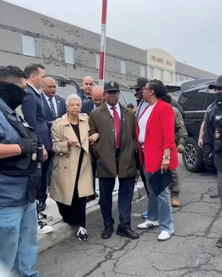 People stand on concrete outside jail