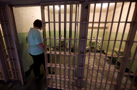 a person walks into a jail cell