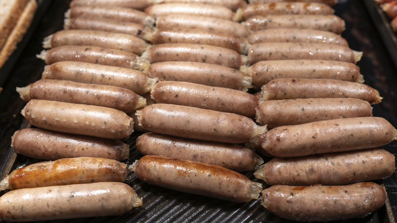 Rows of sausages on a baking tray