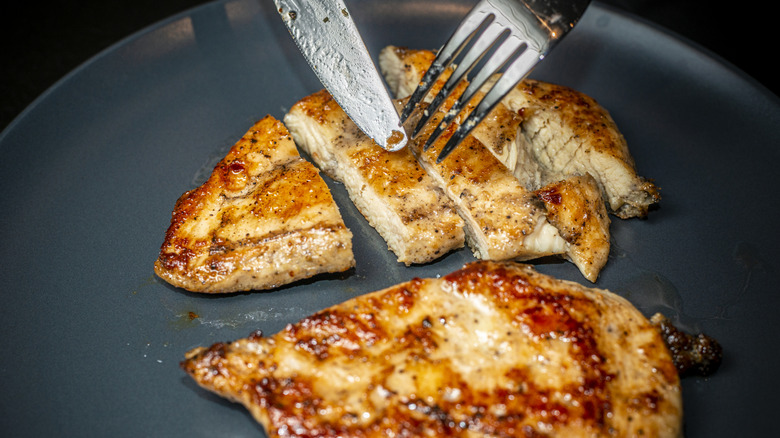 Cutting through a chicken breast